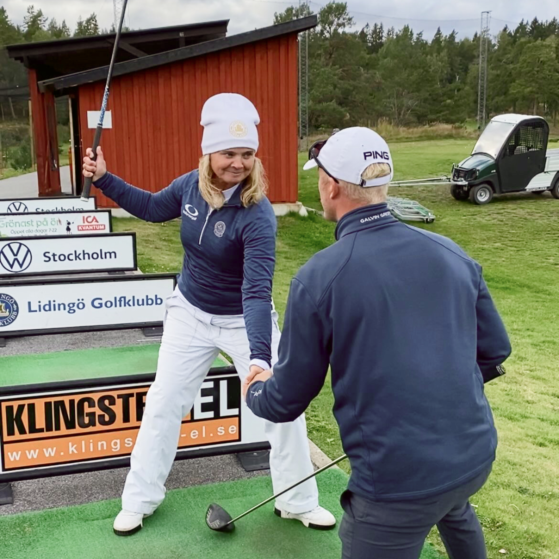 Coach and player working on the swing at the range